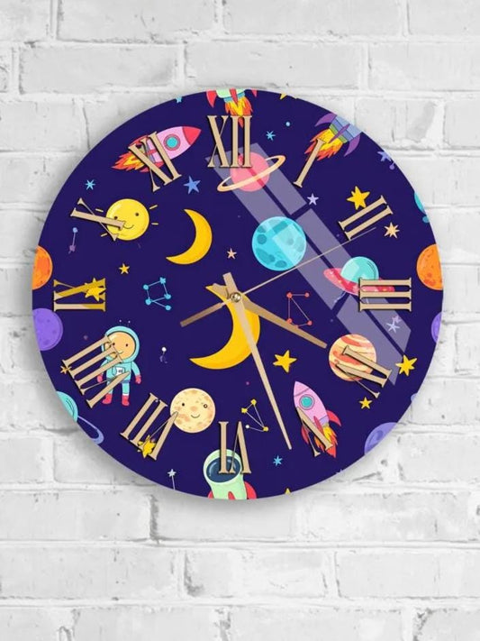 A round wall clock with a space-themed design, featuring various celestial objects such as planets, stars, and a crescent moon.