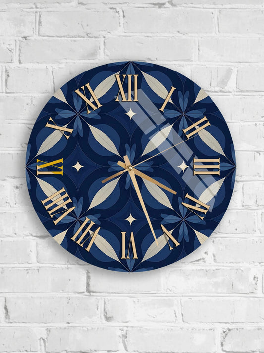 A round wall clock with a blue and gold design, mounted on a white brick wall.