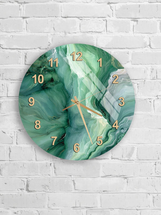 A round wall clock with a marble-like green and white pattern on its face, mounted on a white brick wall.