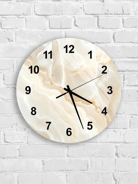 A round wall clock with a marble-like design on a white brick wall.