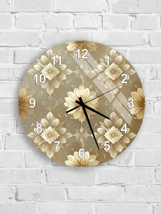 A round wall clock with a floral pattern on its face, mounted on a white brick wall.