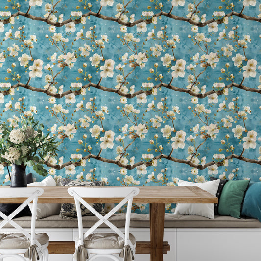 a dining area with a wooden table and chairs, a vase of flowers, and a wallpapered wall with a floral pattern.