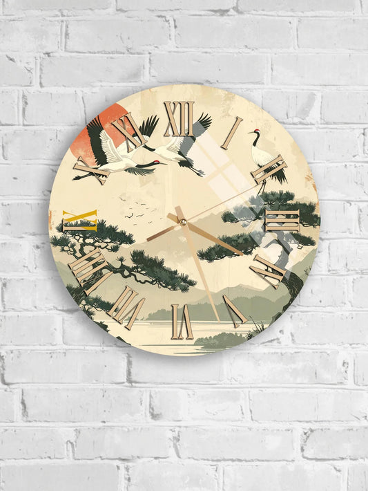 A wall clock with a design featuring birds and trees, mounted on a white brick wall.