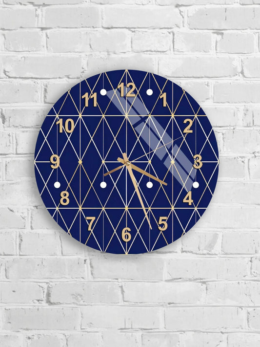 A blue and gold geometric clock with a diamond pattern and gold numbers is mounted on a white brick wall.