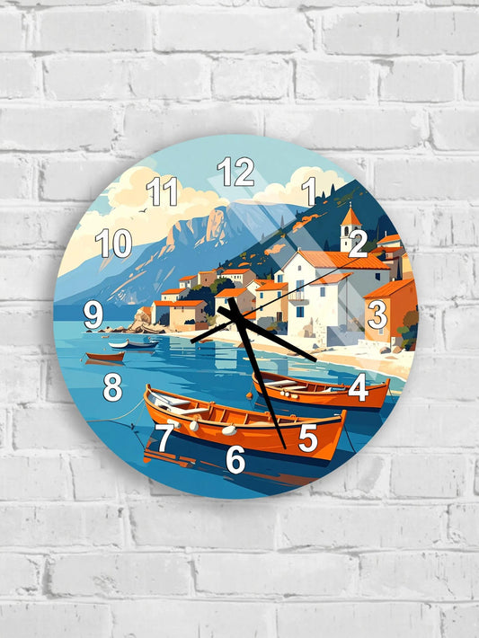 A wall clock with a scenic coastal town design, featuring boats and mountains in the background.