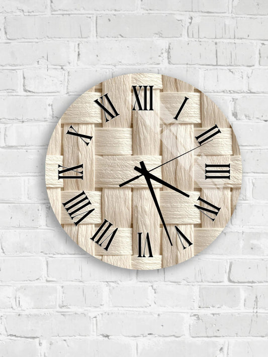 A round clock with Roman numerals on a white brick wall.