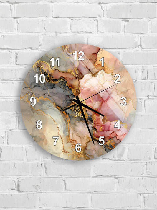 A round wall clock with a marble-like design and gold accents, mounted on a white brick wall.
