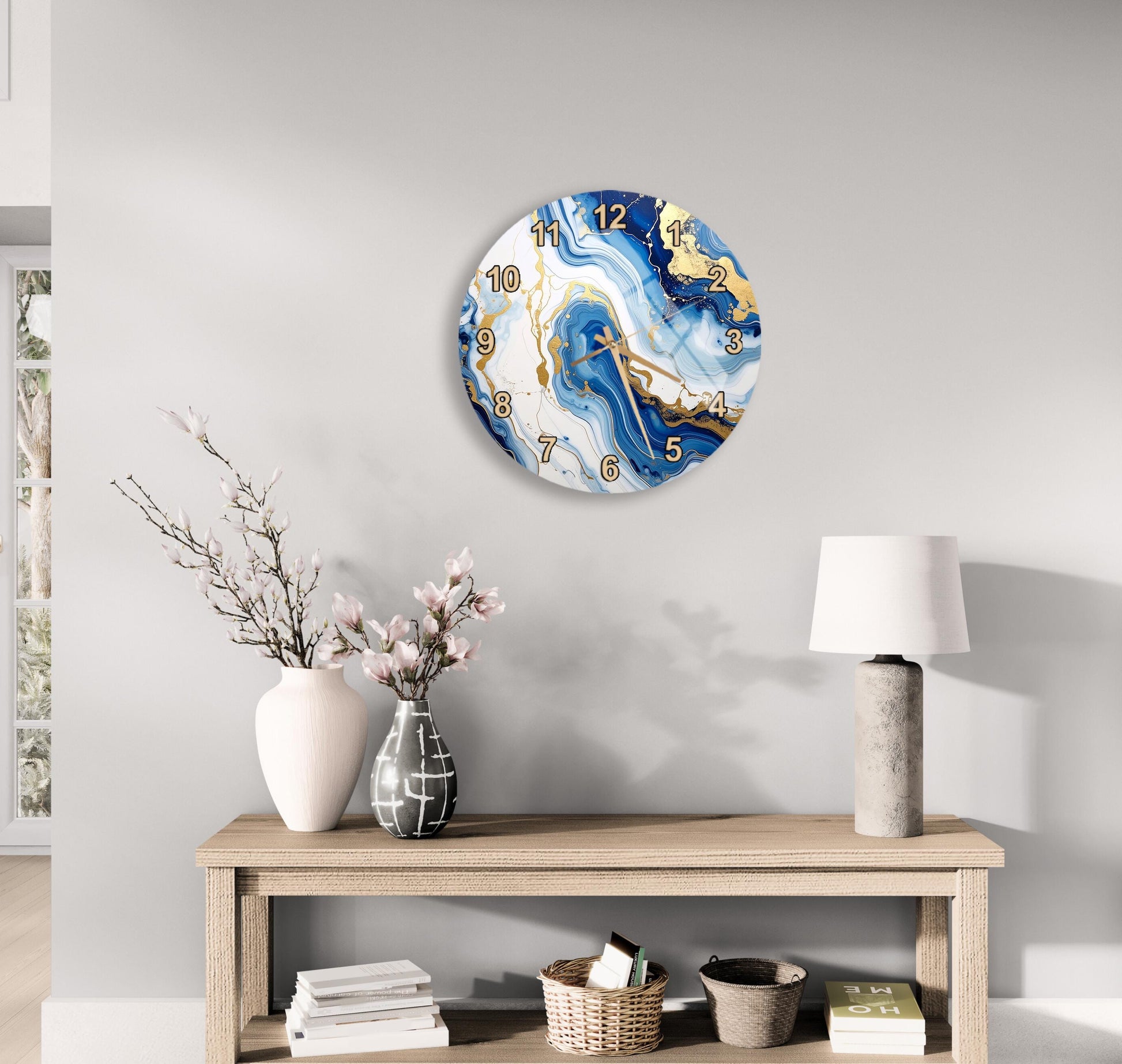 a modern living room with a wooden table displaying a vase of flowers, a lamp, and a clock with a marble-like design.