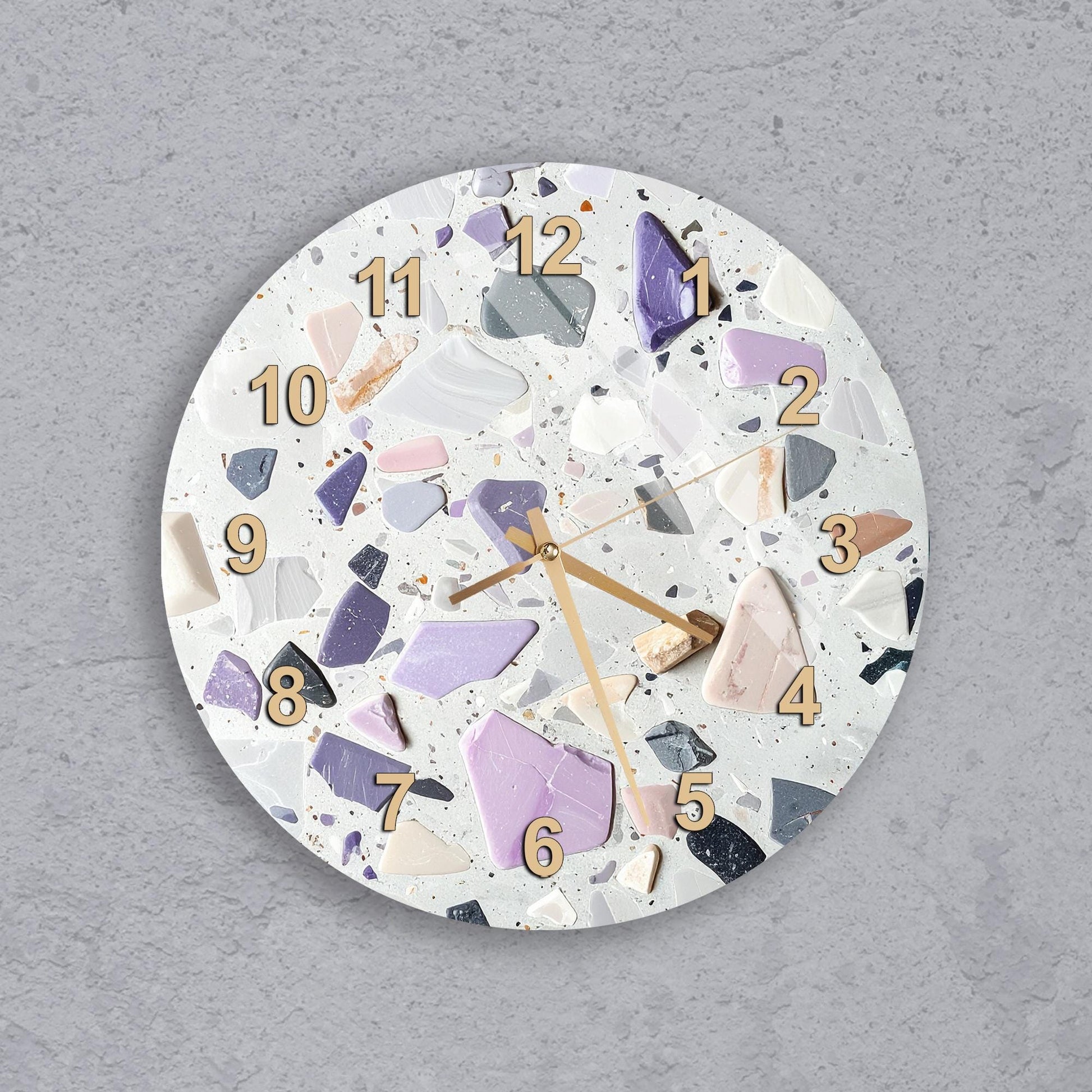 A wall clock with a unique design made of colorful, irregularly shaped pieces, creating a visually striking and artistic appearance.