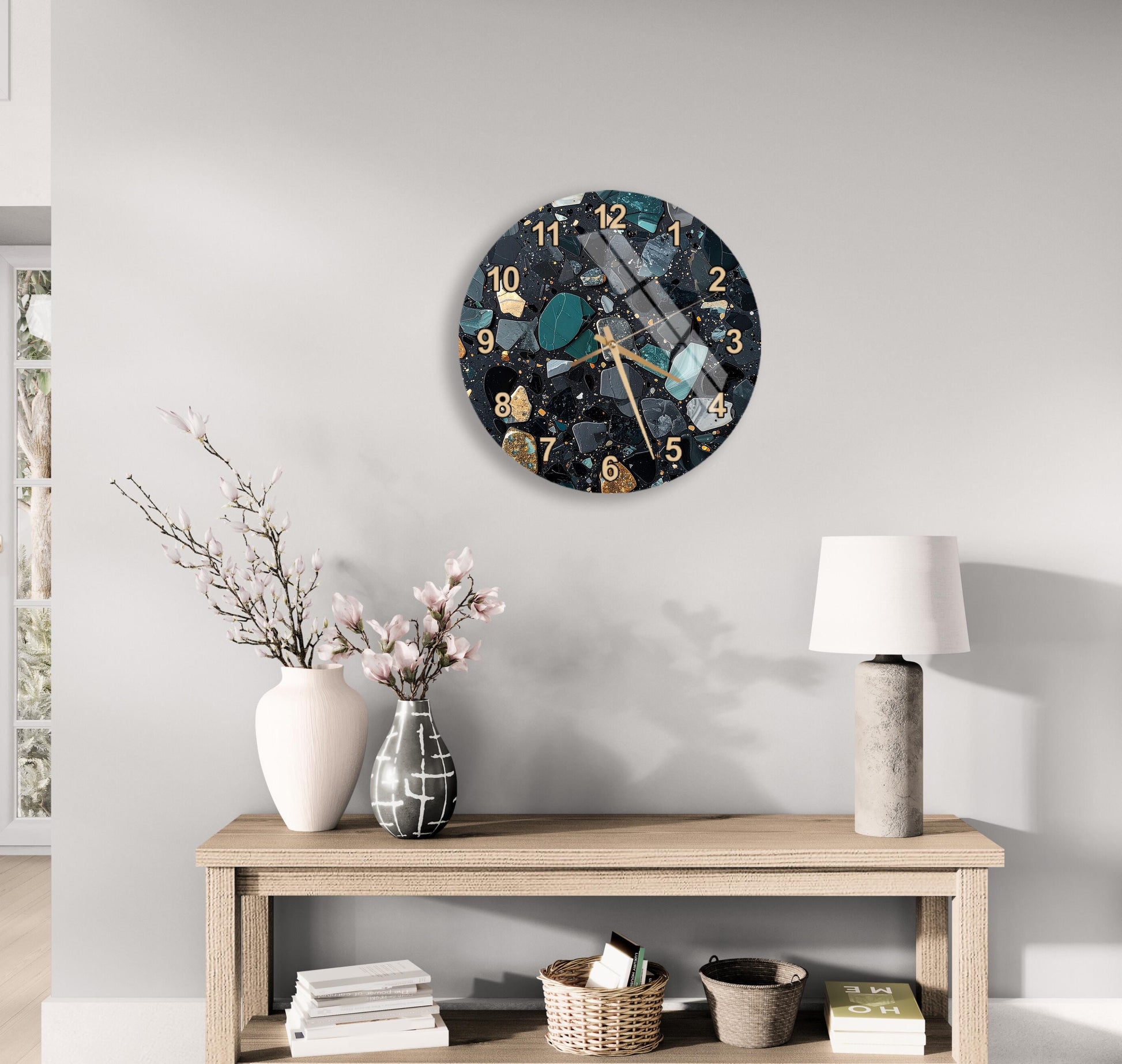 a modern living room with a wooden table displaying a clock, a vase with flowers, and a lamp. The clock has a mosaic design with various colors and patterns.