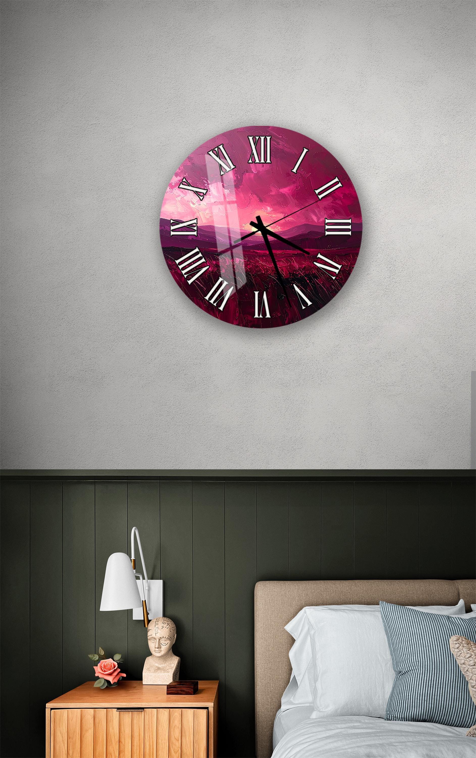 a bedroom setting with a large wall clock displaying a sunset scene, a wooden nightstand with a lamp, and a bed with white pillows.