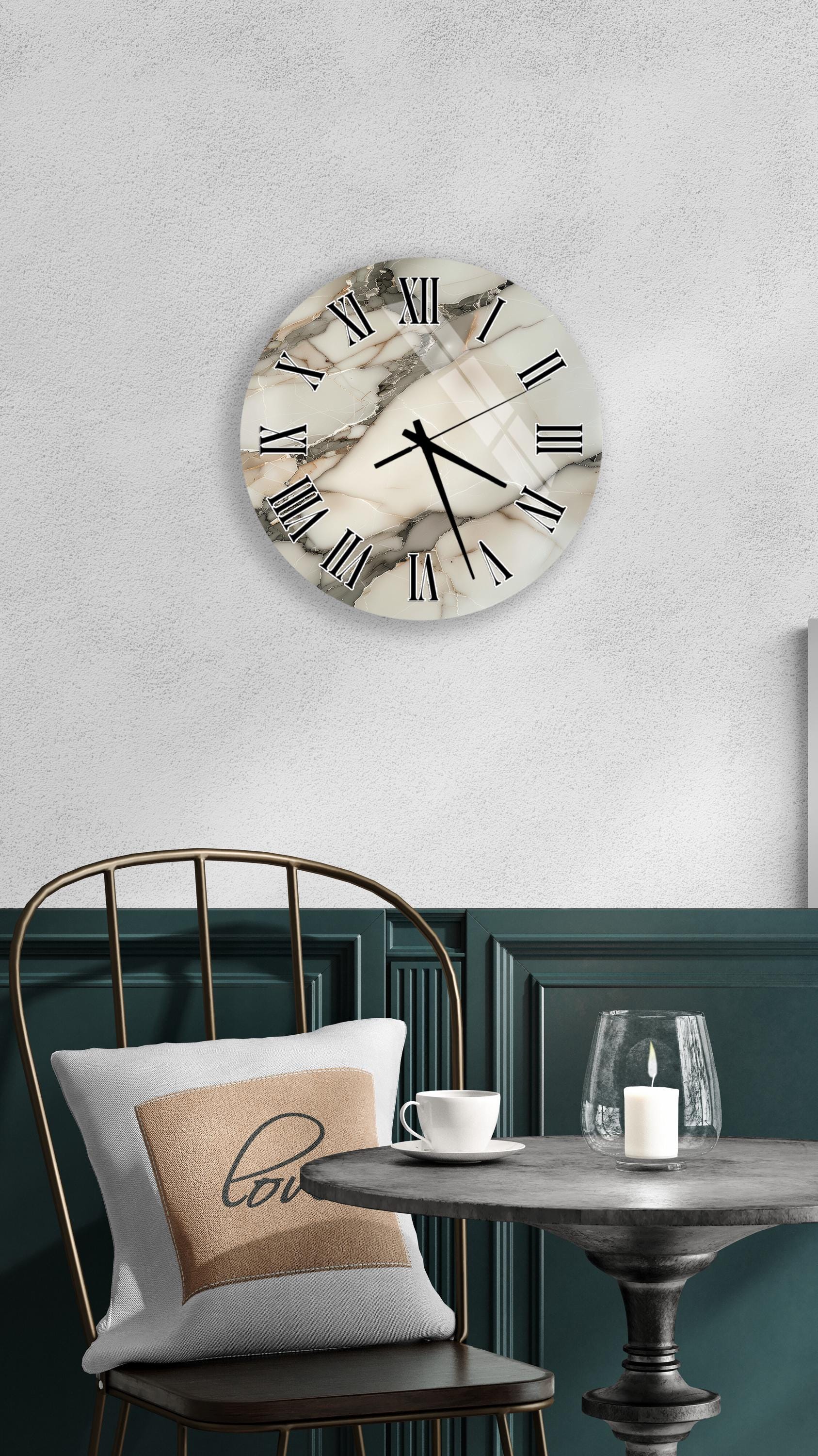 a modern interior design with a round wall clock, a black metal chair, a white table with a candle, and a beige pillow with the word "love" on it.