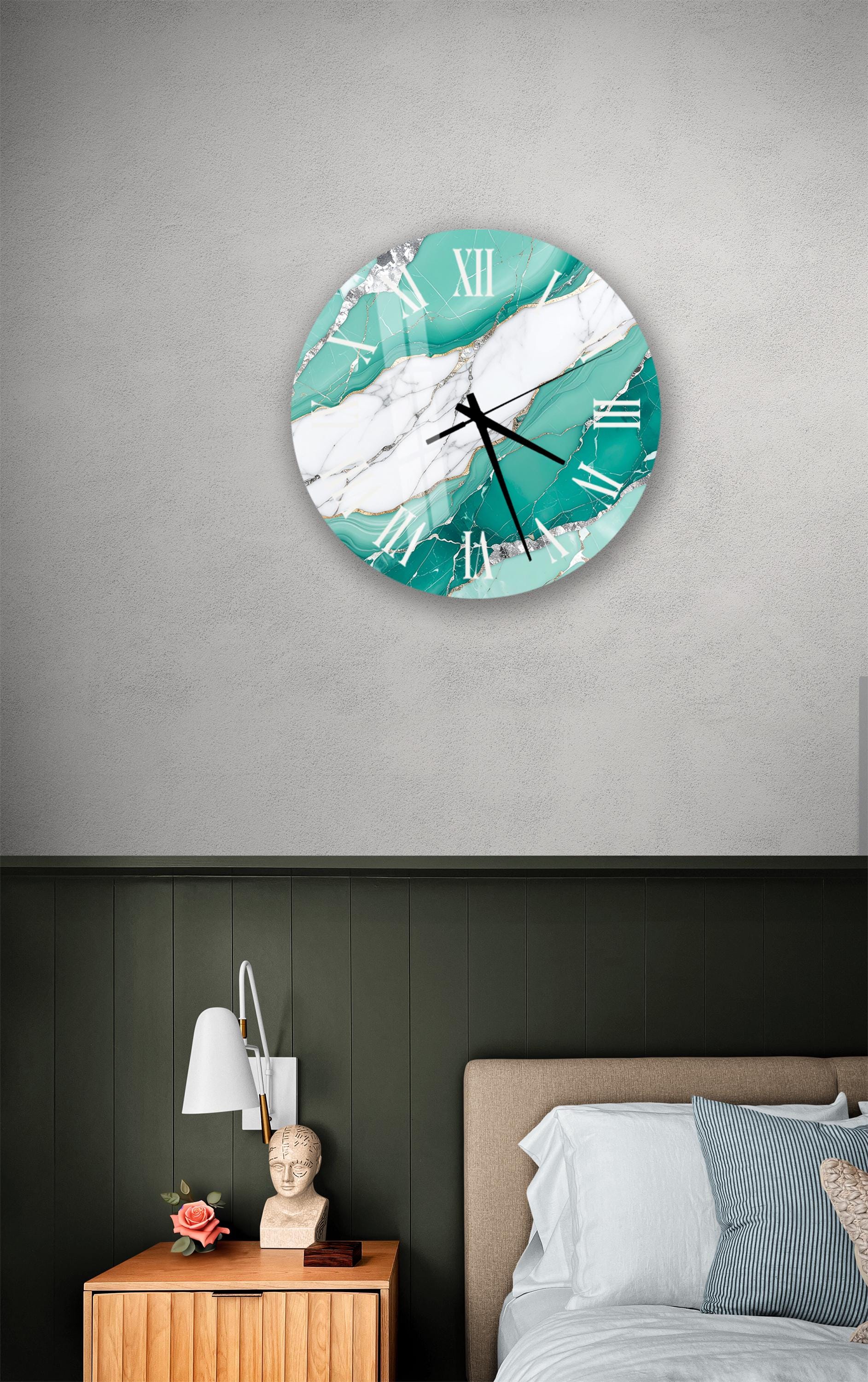 a bedroom setting with a large turquoise and white clock on the wall above a bed with a white headboard.