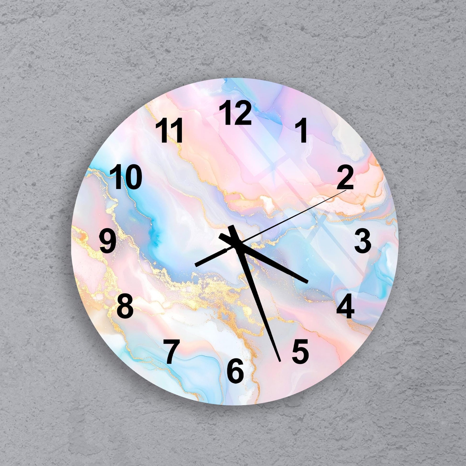 A wall clock with a marble-like design on its face, featuring numbers 1 through 12 and a black hand pointing to the 12 o'clock position.