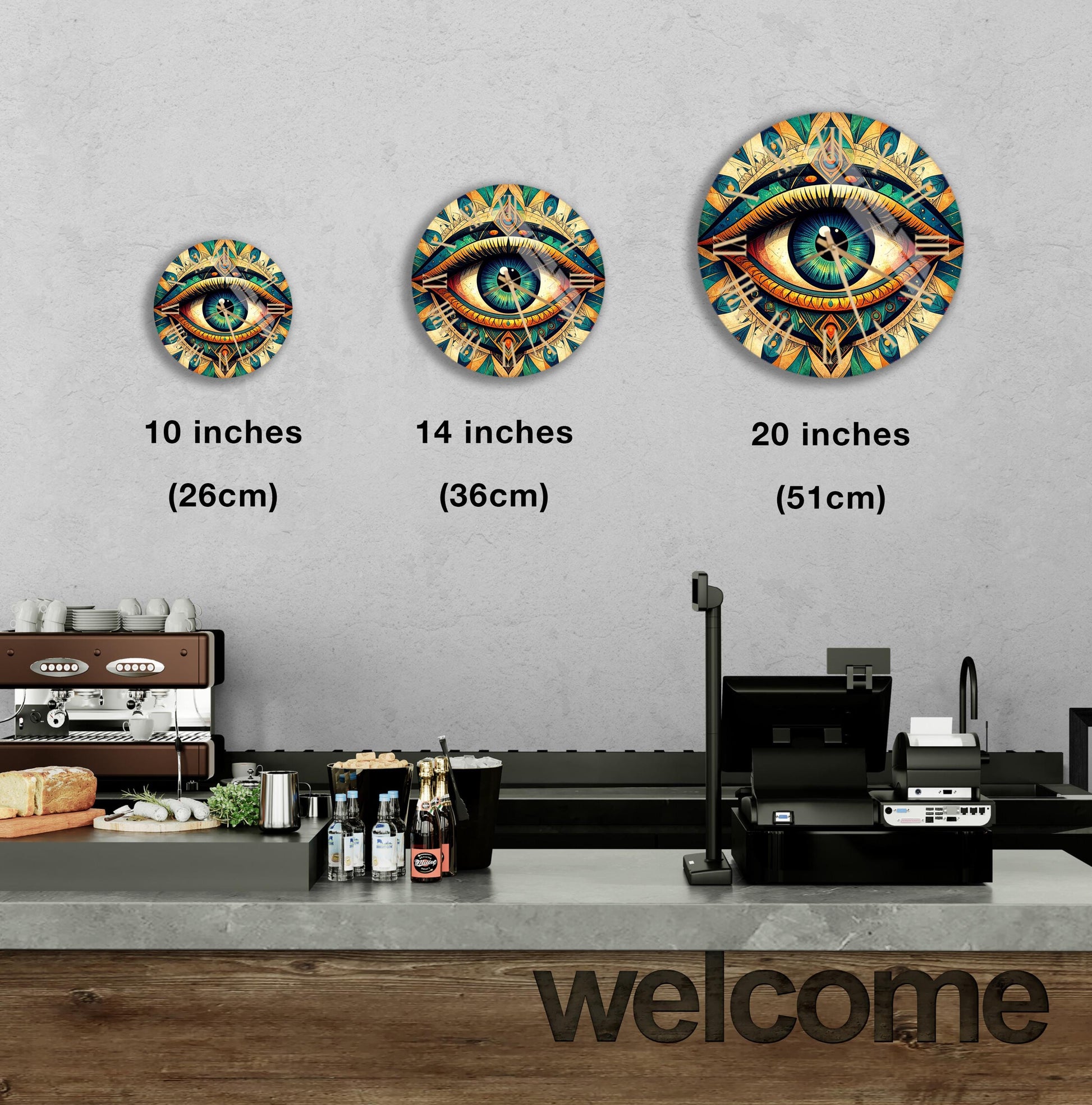 a wall with three different sizes of circular wall art depicting an eye design, and there is a counter with various items on it, such as bottles and a sandwich.