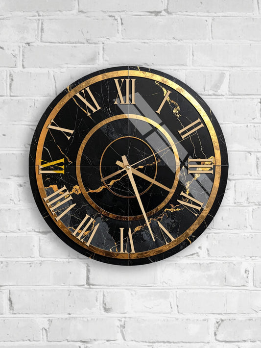 A black and gold wall clock with Roman numerals is mounted on a white brick wall.