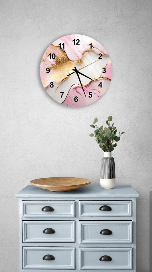 a wall clock with a pink and white marble design, mounted on a wall above a light blue dresser with six drawers. The dresser also has a vase with greenery on it, and there is a wooden plate on the dresser.
