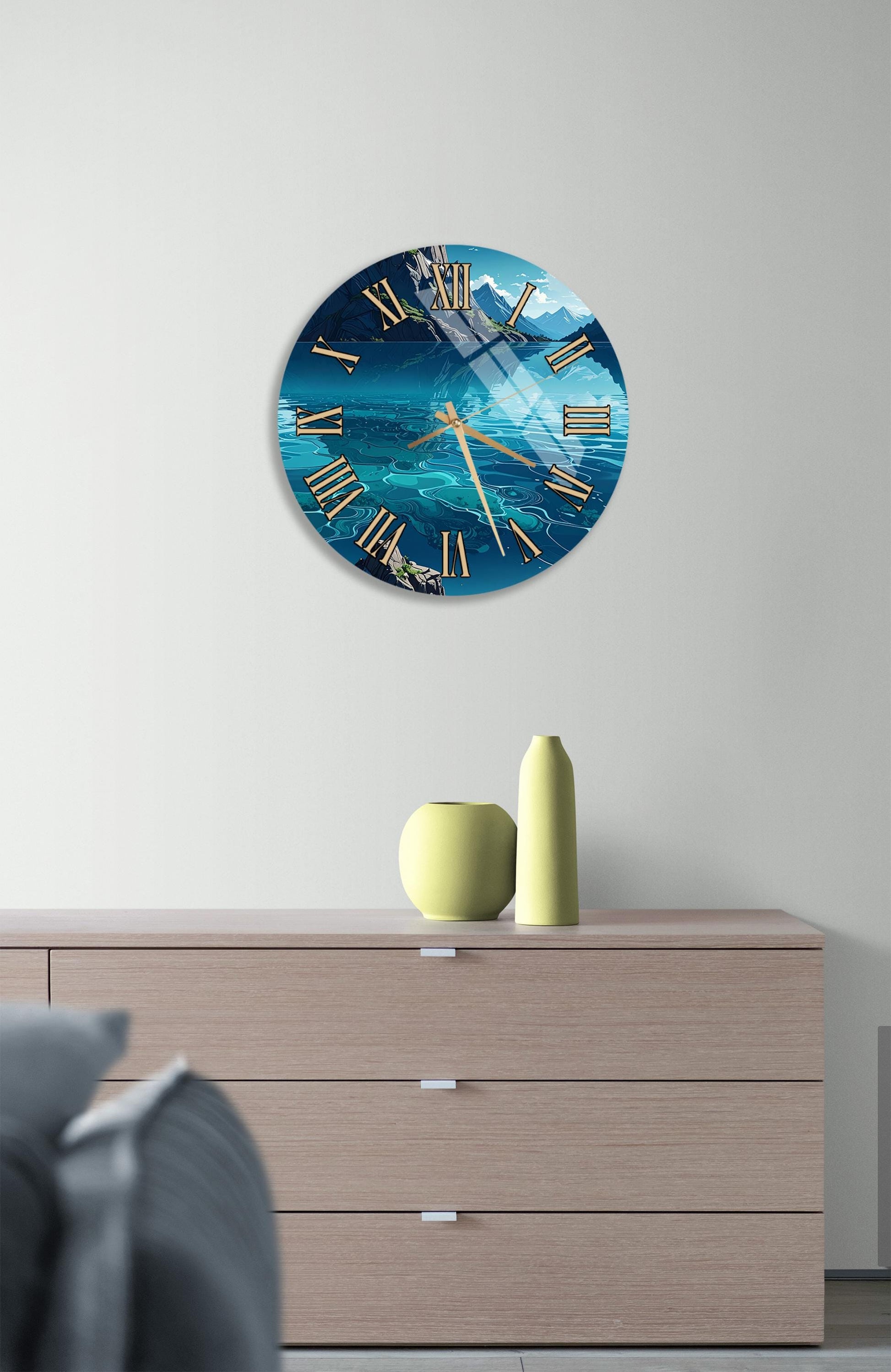 a wall clock with a blue ocean scene and a yellow vase on a wooden dresser.