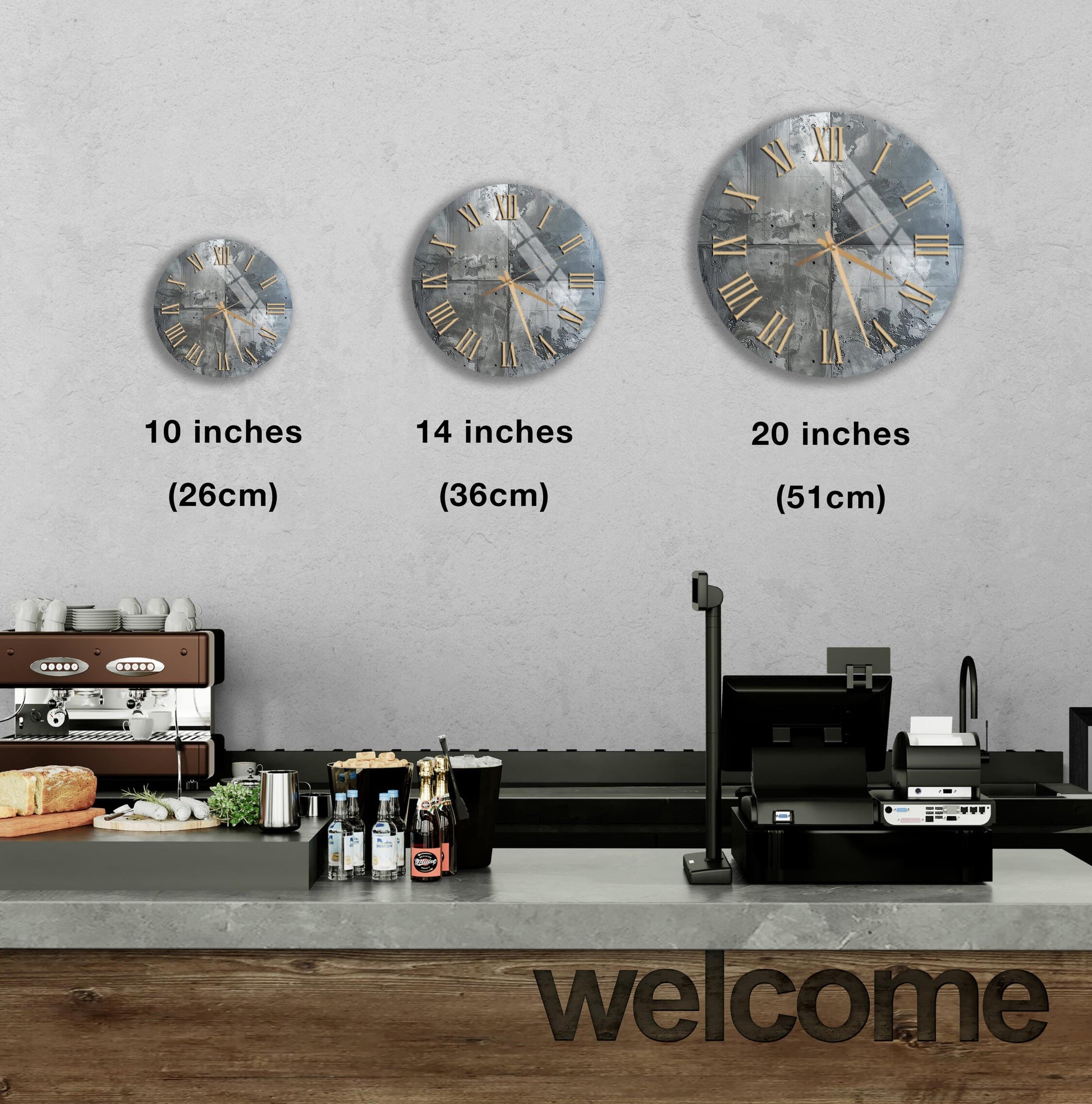 a wall with three different clock sizes, ranging from 10 inches to 20 inches, and a counter with various items such as bottles and a sandwich.
