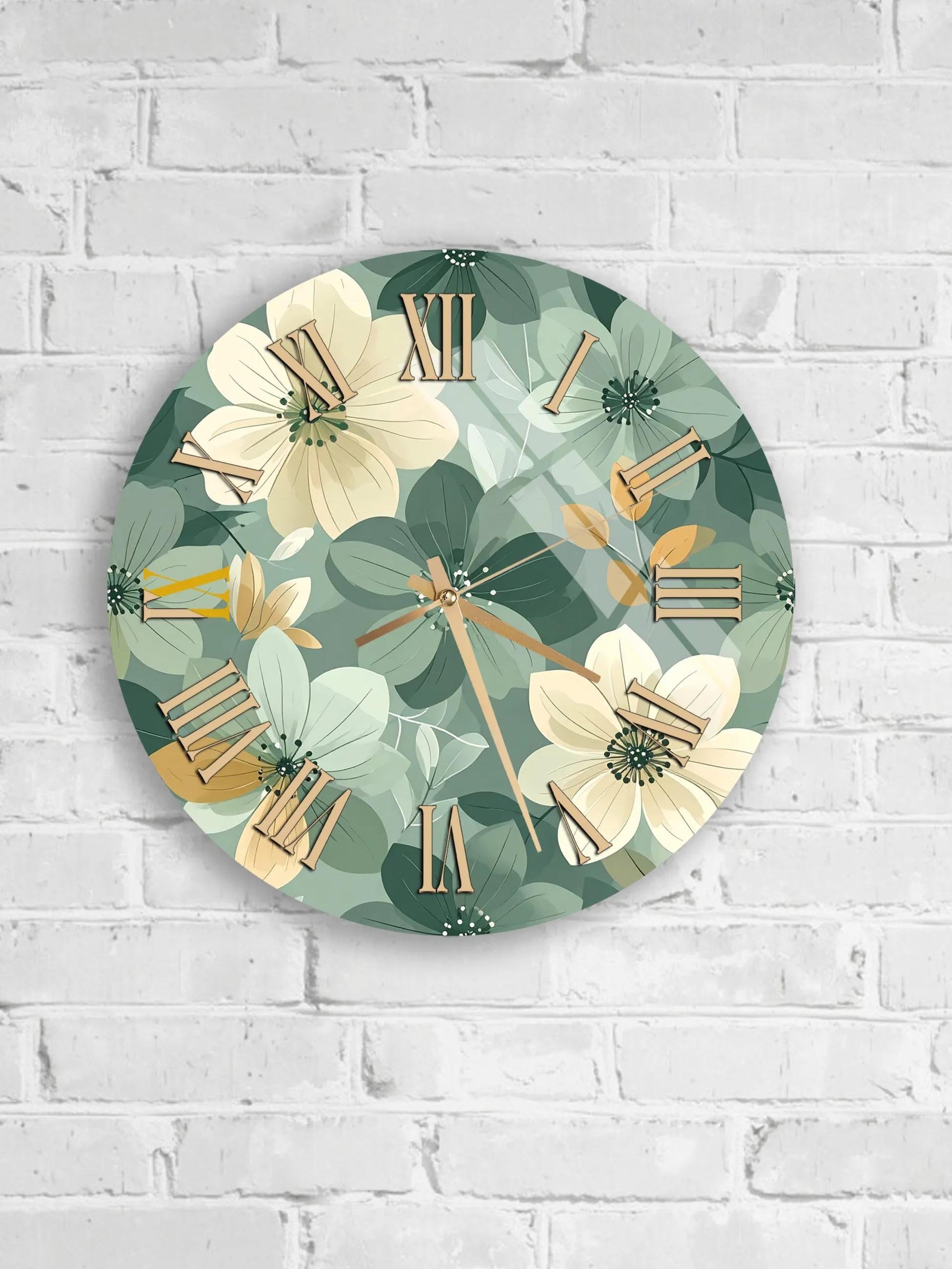 A round wall clock with a floral pattern on the face, mounted on a white brick wall.