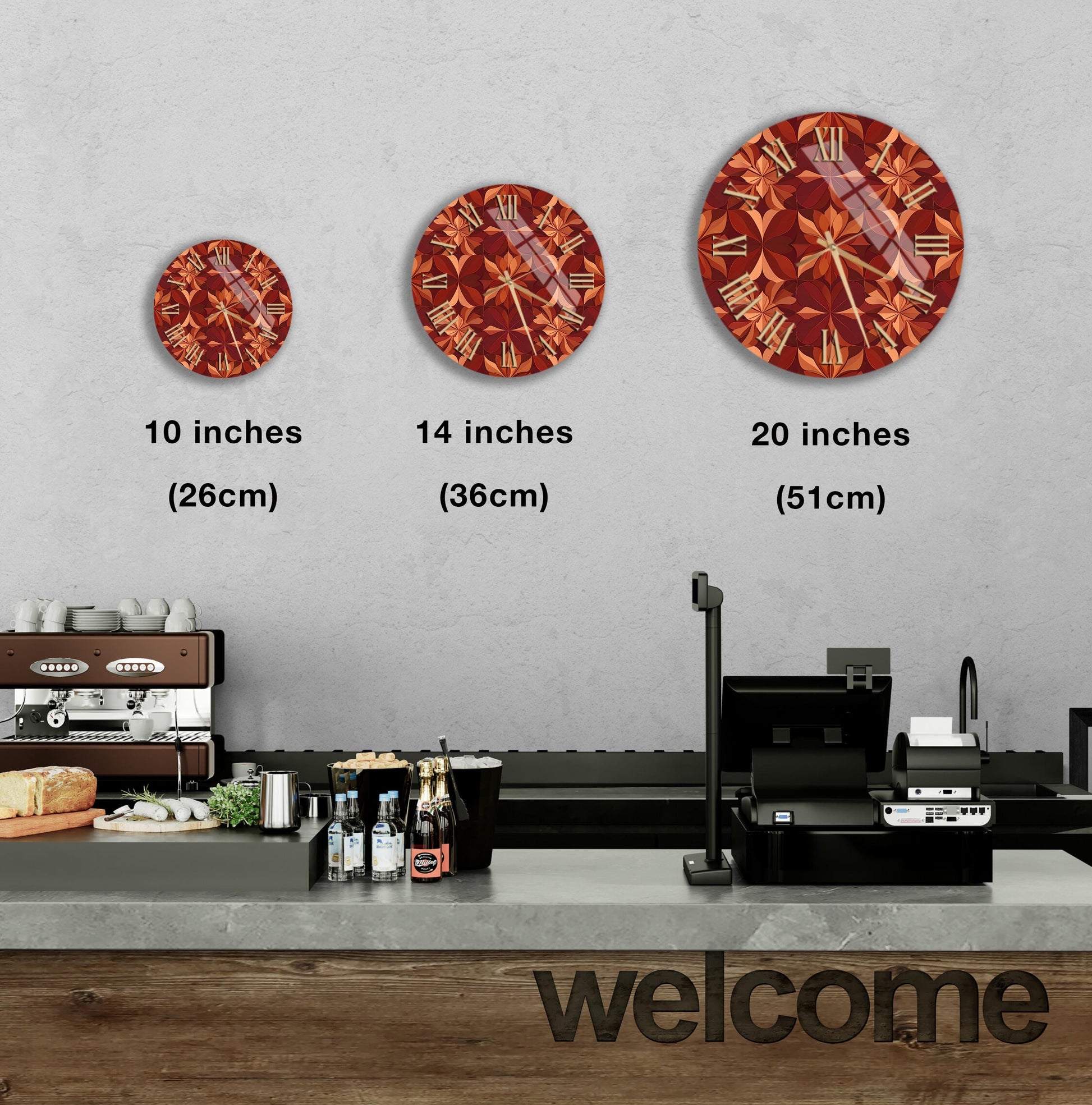 a wall with three clock designs of different sizes, ranging from 10 inches to 20 inches in diameter. Below the clocks, there is a counter with various items such as bottles and a sandwich. The word "welcome" is also visible in the image.