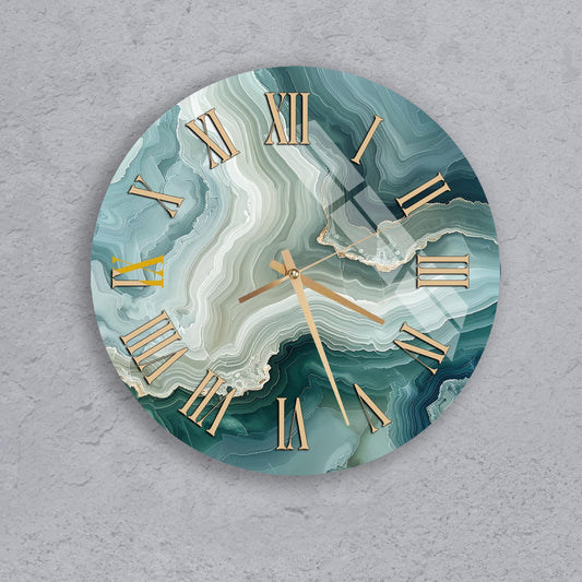 A round clock with a marble-like design on its face, featuring Roman numerals and gold hands.