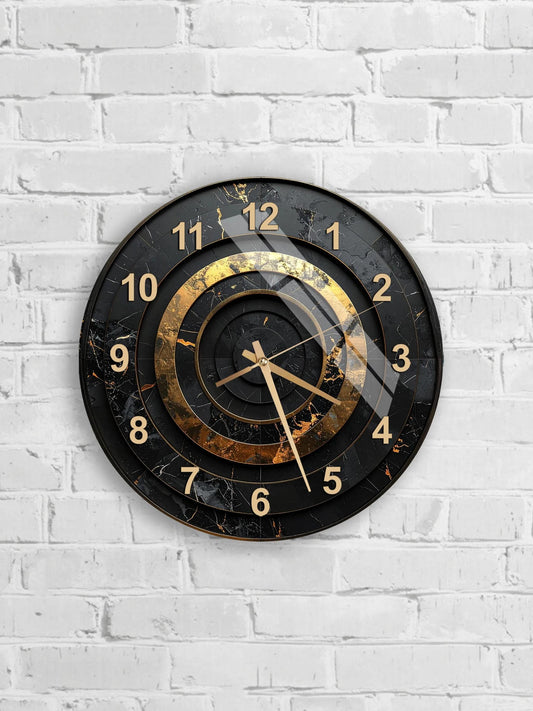 A black and gold wall clock with a marble-like finish is mounted on a white brick wall.