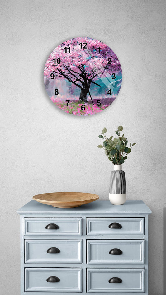 a wall clock with a pink tree design, a wooden bowl on a light blue dresser, and a vase with greenery.