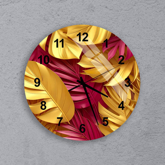 A round wall clock with a vibrant design featuring yellow and pink leaves.