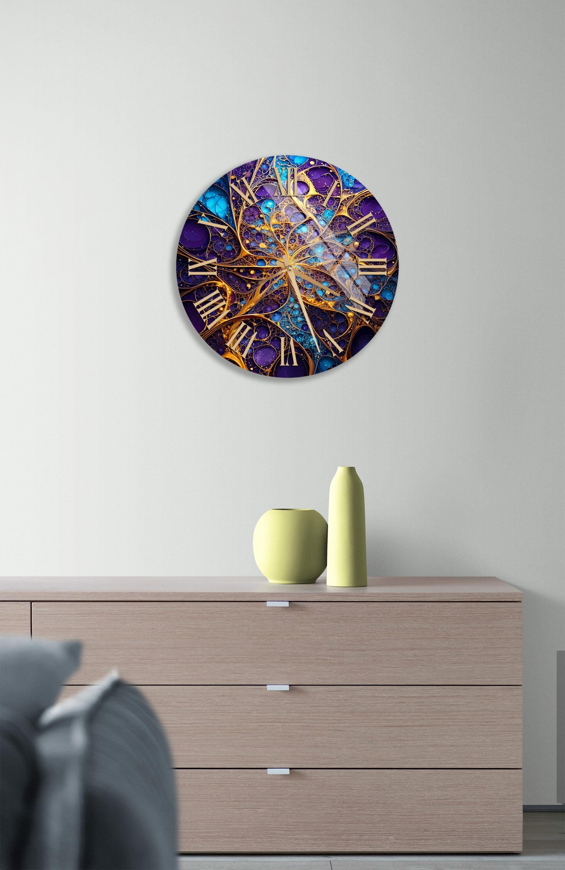 a large clock on a wall above a dresser