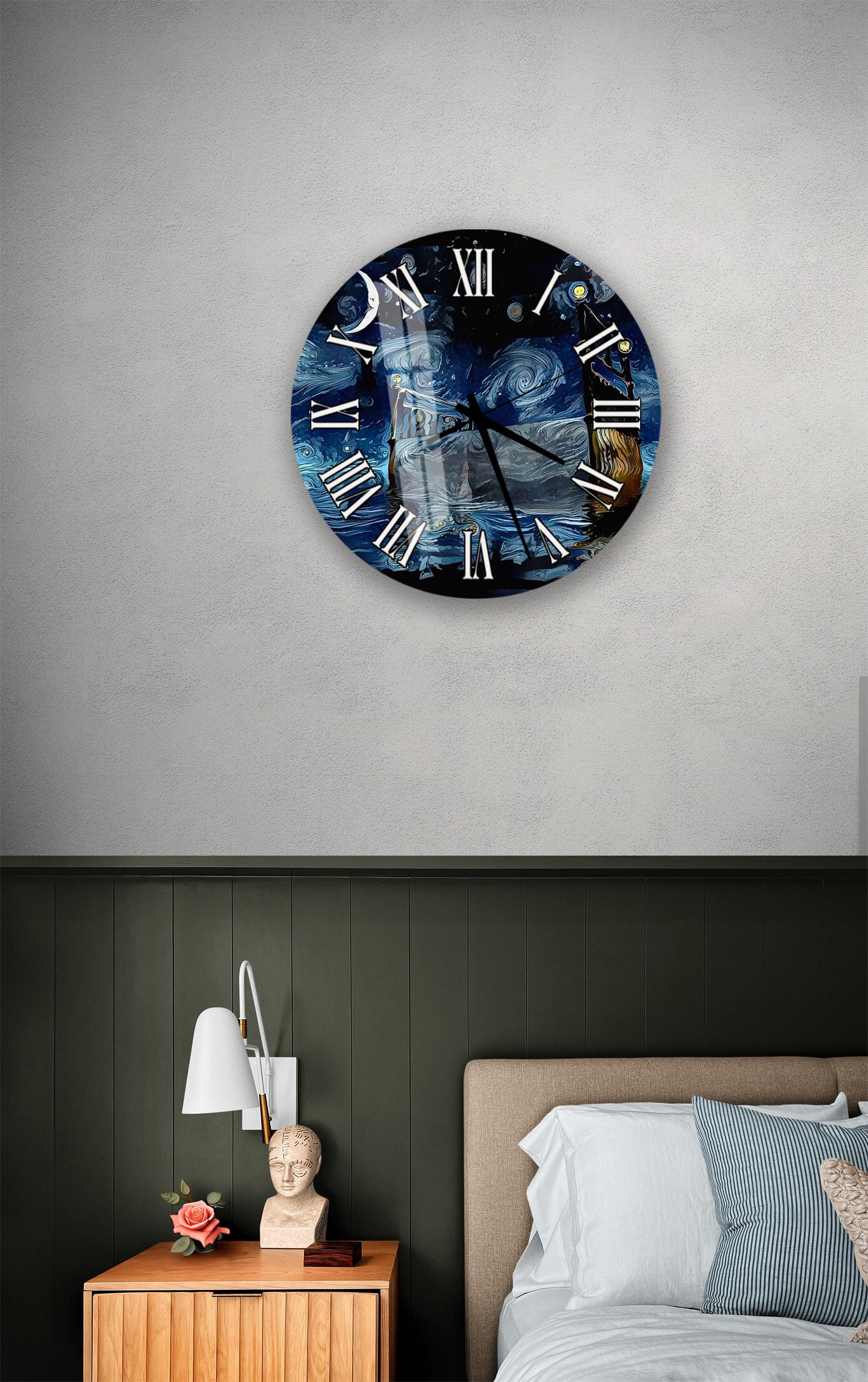 a bedroom setting with a large wall clock displaying a night sky scene, a wooden nightstand with a lamp, and a bed with white pillows.