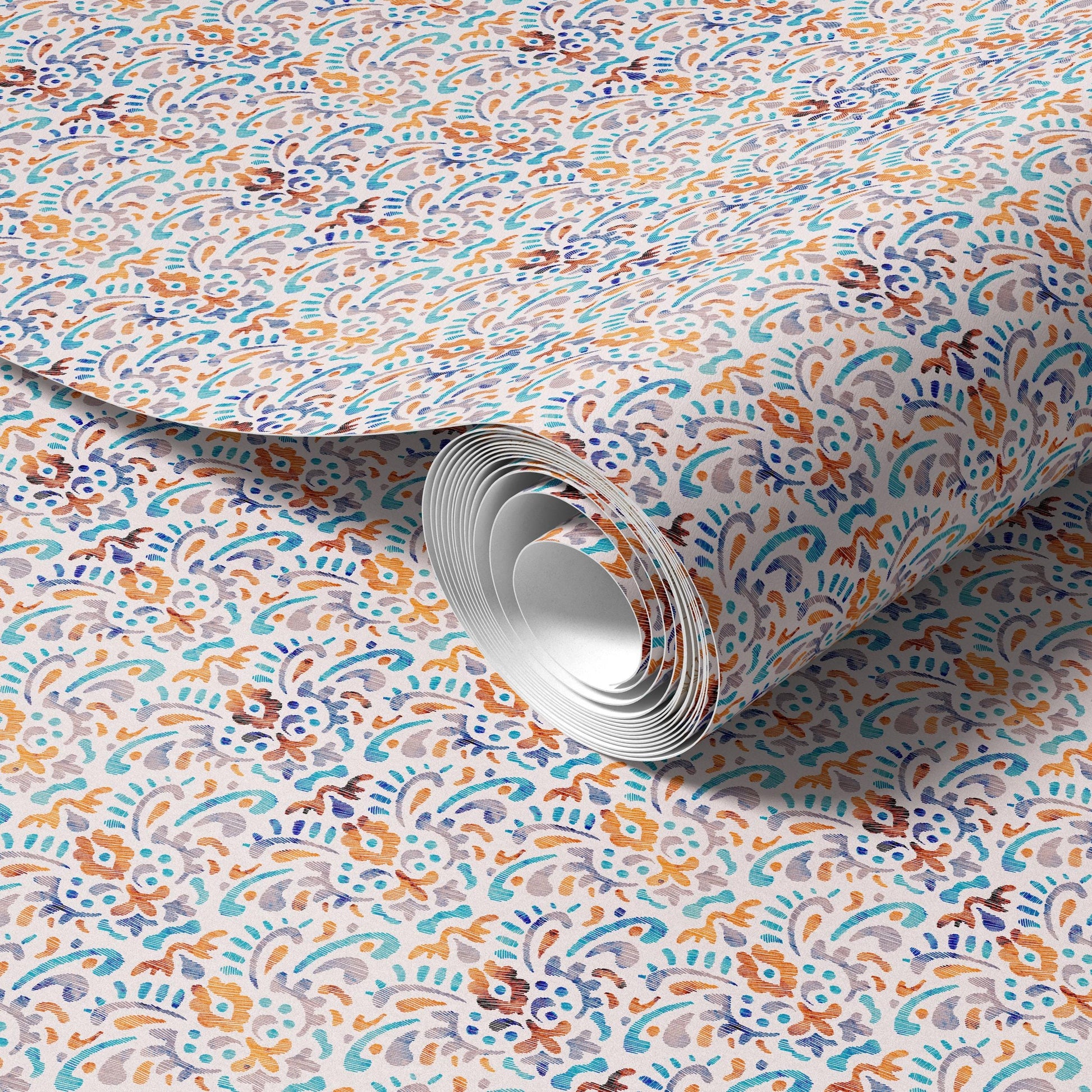 a roll of patterned wallpaper or paper with a repeating floral or paisley design in various shades of blue, orange, and green.
