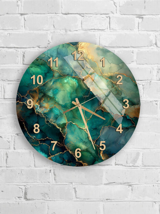A round wall clock with a marble-like design in shades of green and gold, mounted on a white brick wall.