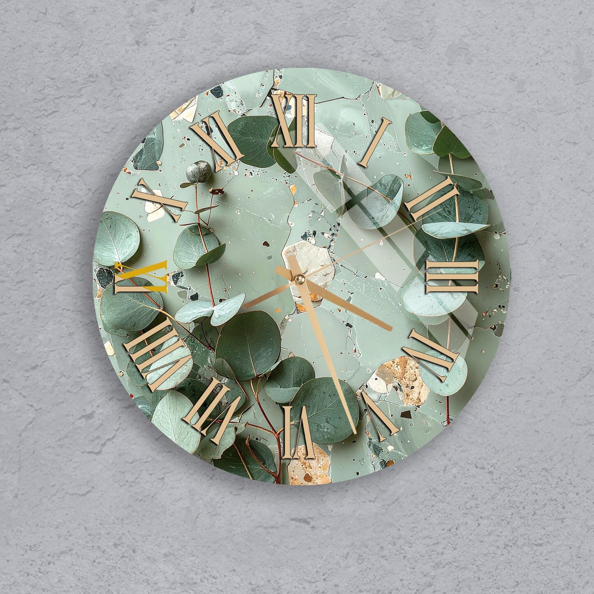 A wall clock with a green leafy background and gold Roman numerals.