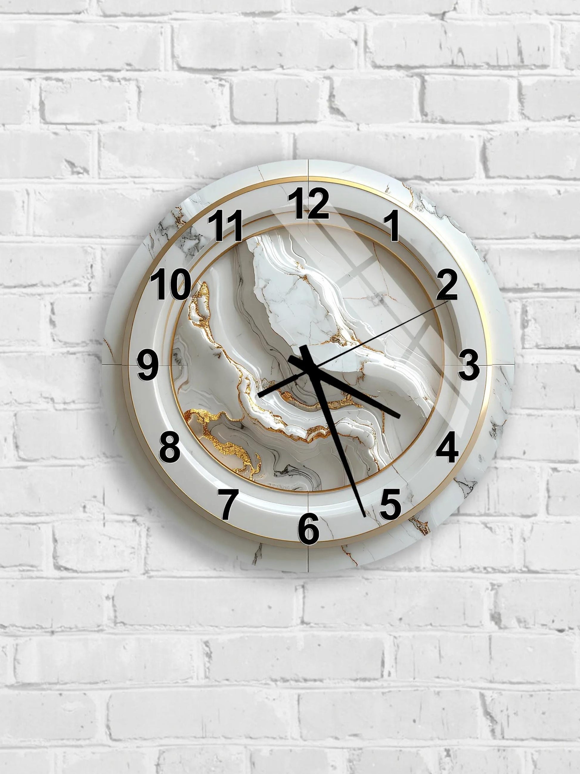 A white wall clock with a marble-like design and gold accents.