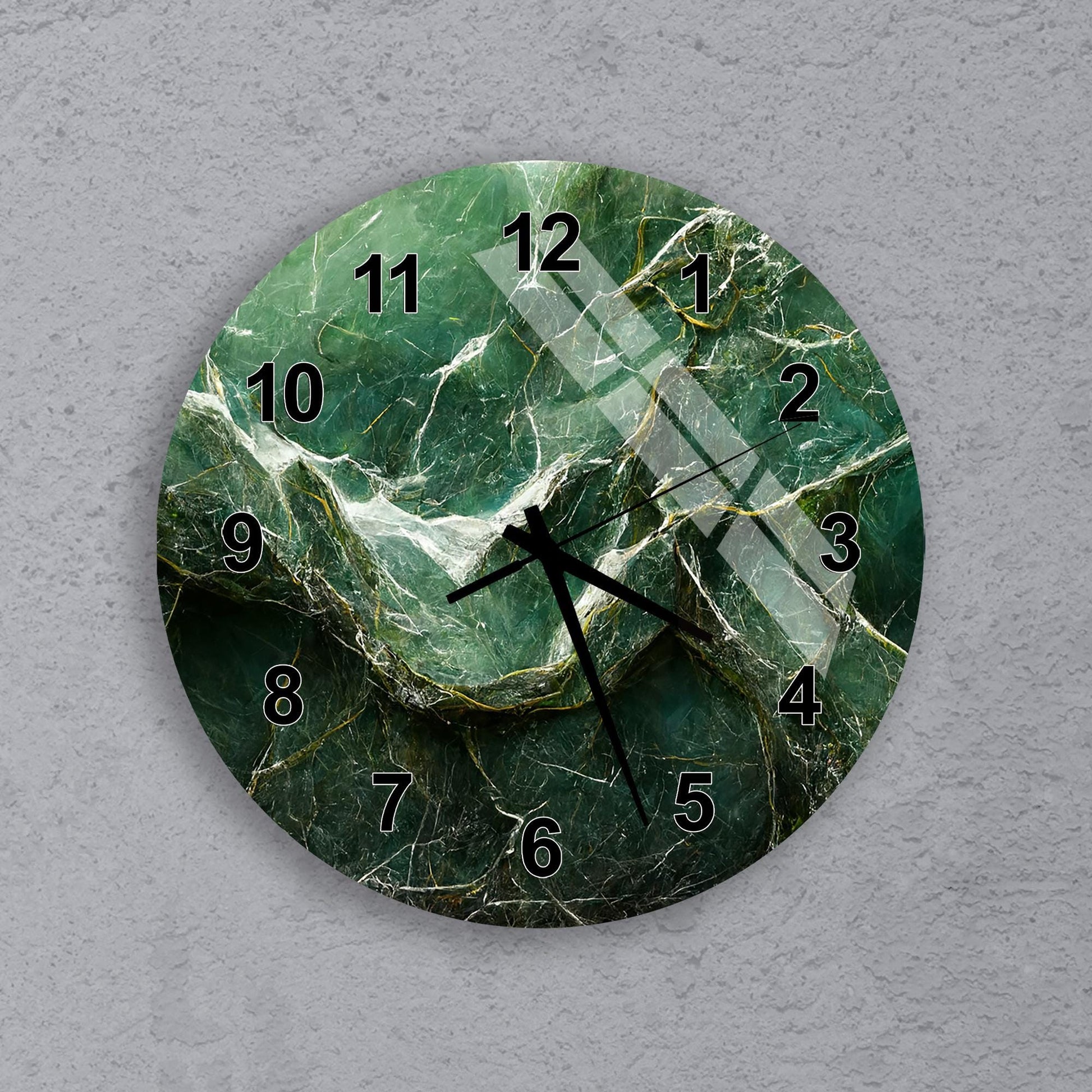 A wall clock with a green marble-like design and black hands and numbers.