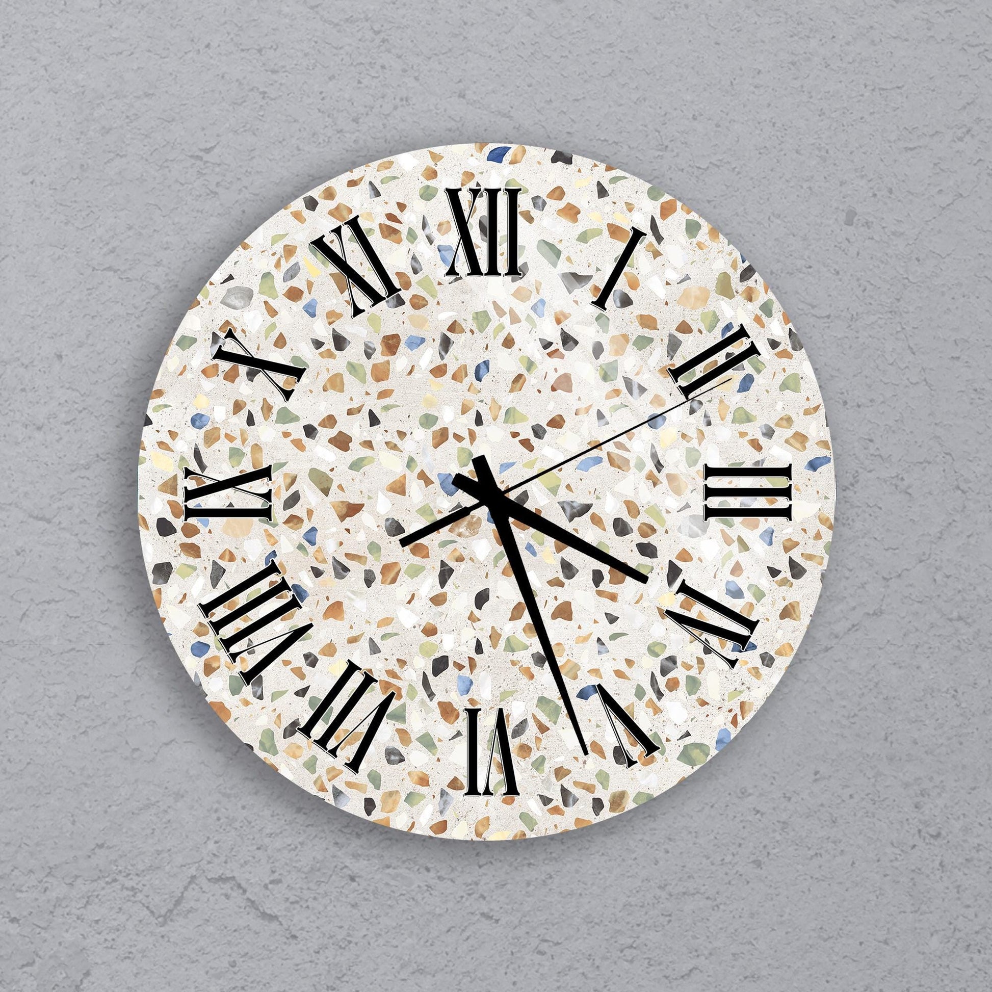 A round wall clock with a mosaic pattern on its face, displaying the time as approximately 10:10.