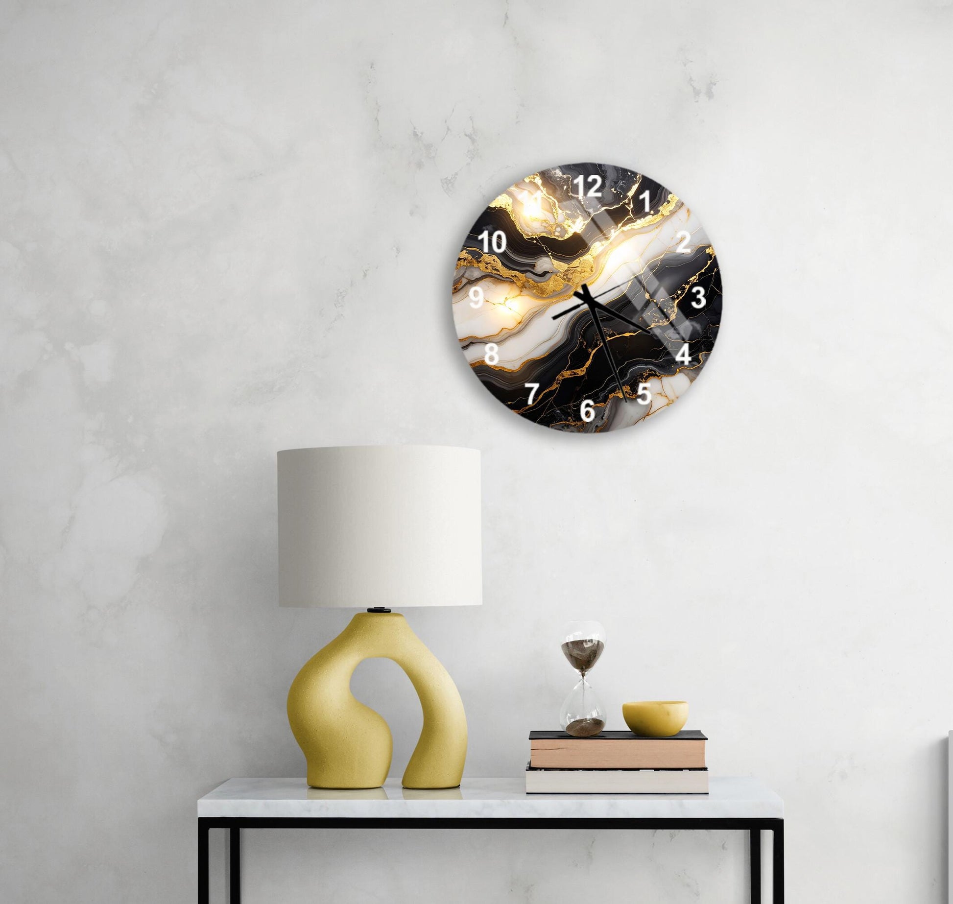 a modern living room with a white marble wall, a round clock with a marble design, a yellow lamp with a unique curved base, a stack of books, and a glass of wine on a white table.