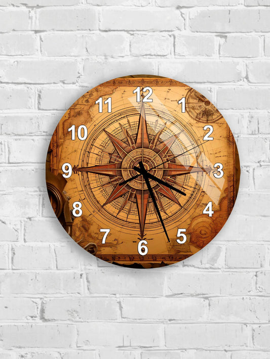 A wall clock with a compass rose design on its face, mounted on a white brick wall.