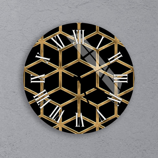a clock with a black and gold geometric design on a gray background.