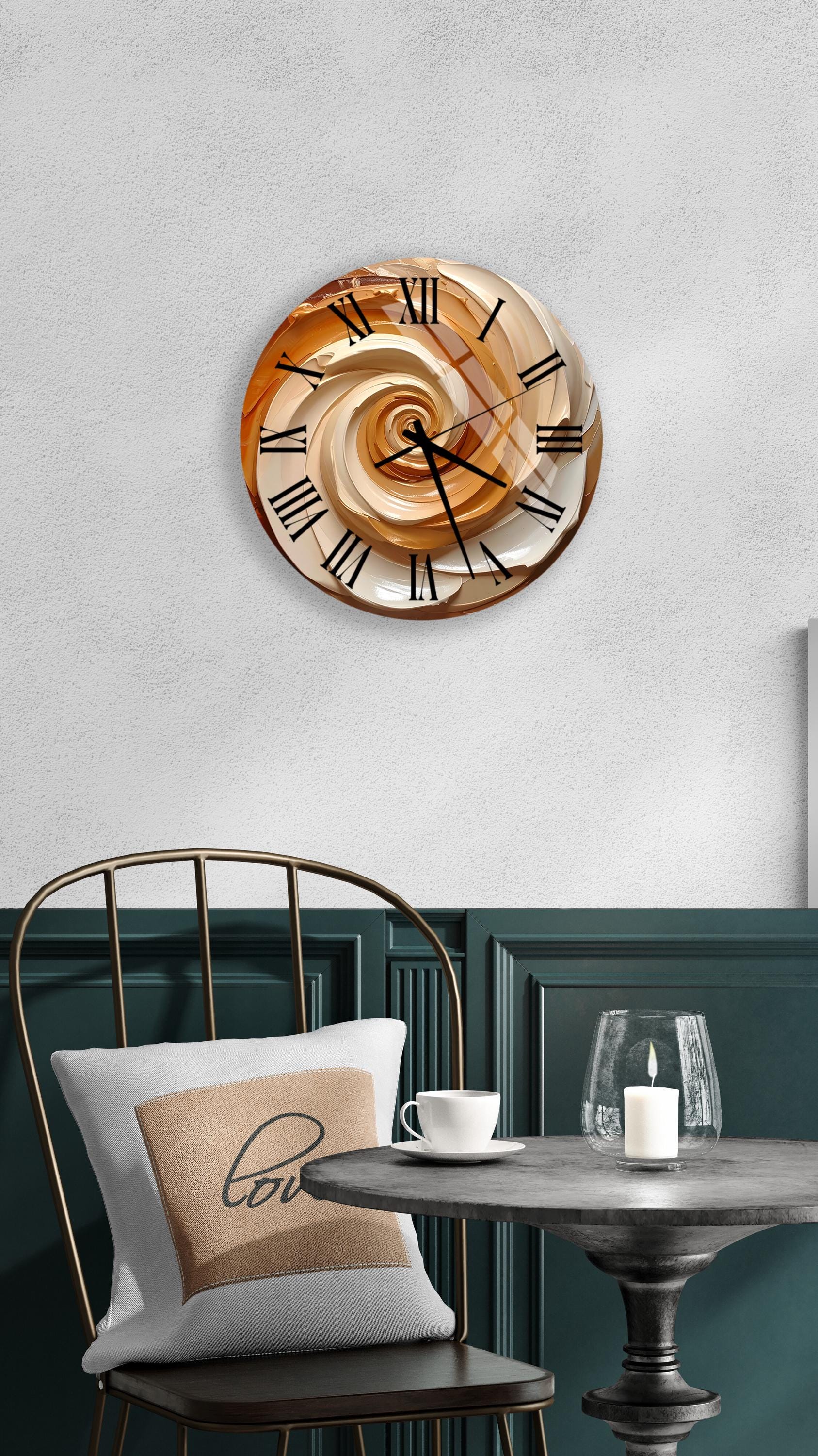 a modern and stylish interior design with a round wall clock displaying a spiral pattern, a white table with a glass candle and a white cup, and a black metal chair with a white pillow.