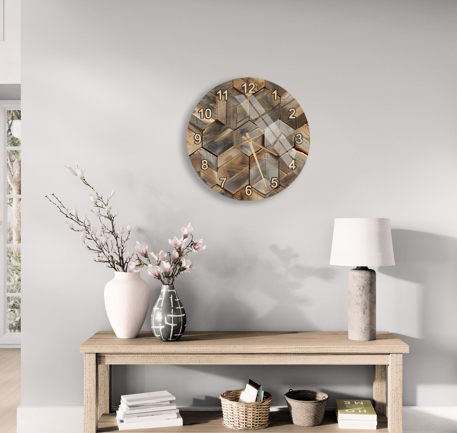 a wooden table with a clock, a vase with flowers, and a lamp on it, set against a light gray wall.