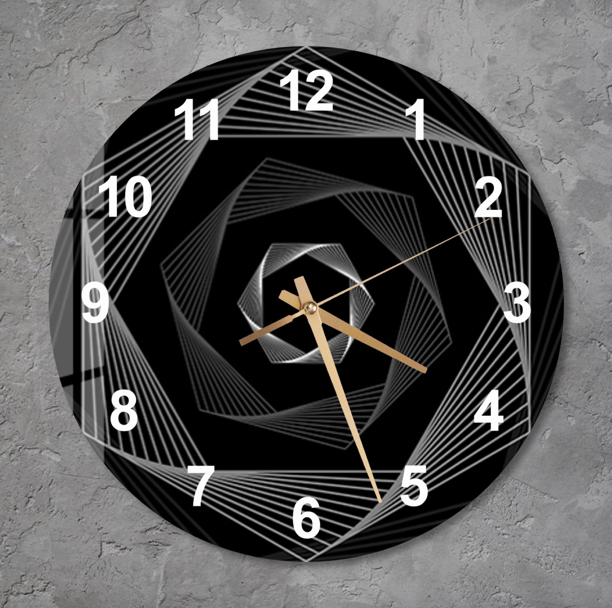 a black and white clock on a gray wall