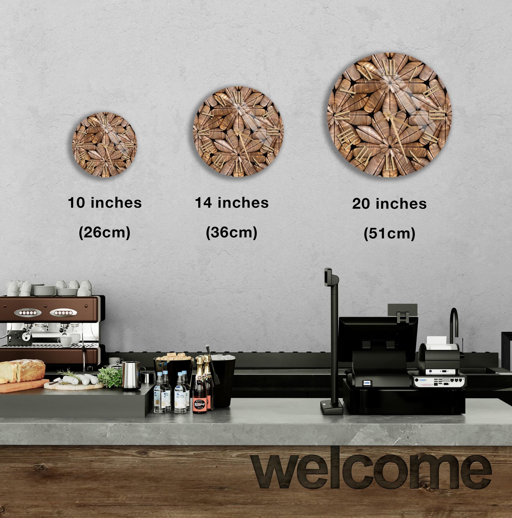 a counter in a restaurant with a welcome sign, and three different sizes of circular wall art displayed above the counter.