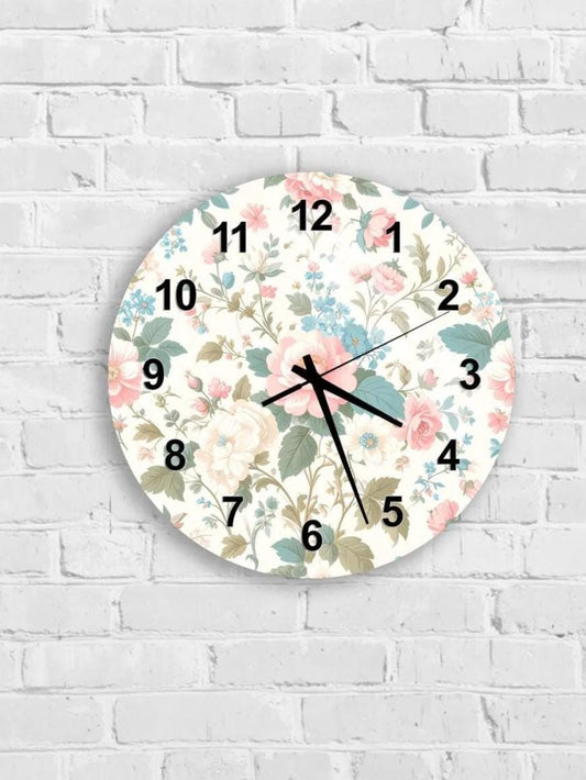 A wall clock with a floral pattern on the face, mounted on a white brick wall.