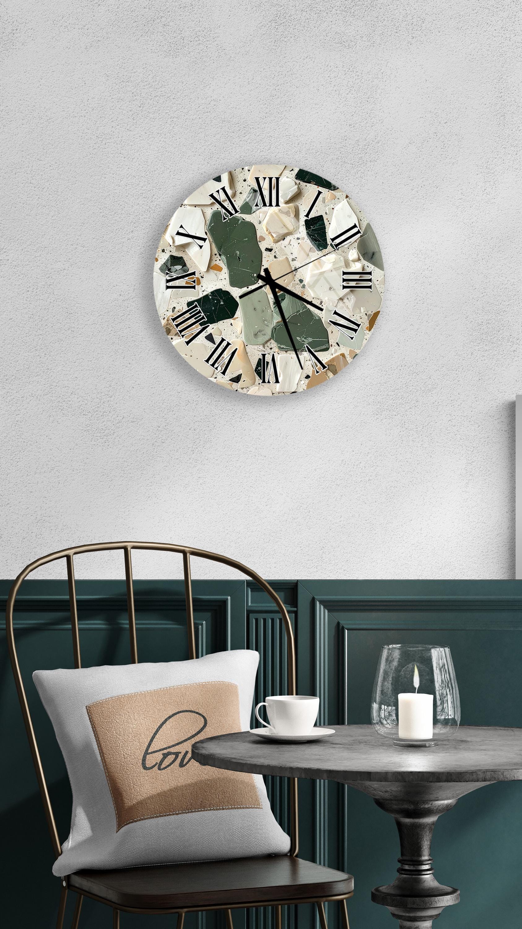 a modern interior design with a round wall clock, a white table with a candle, and a green chair.