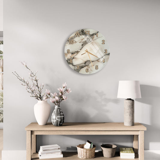 a modern and minimalist living room with a round wall clock, a wooden table with a lamp, a vase with flowers, and a stack of books.