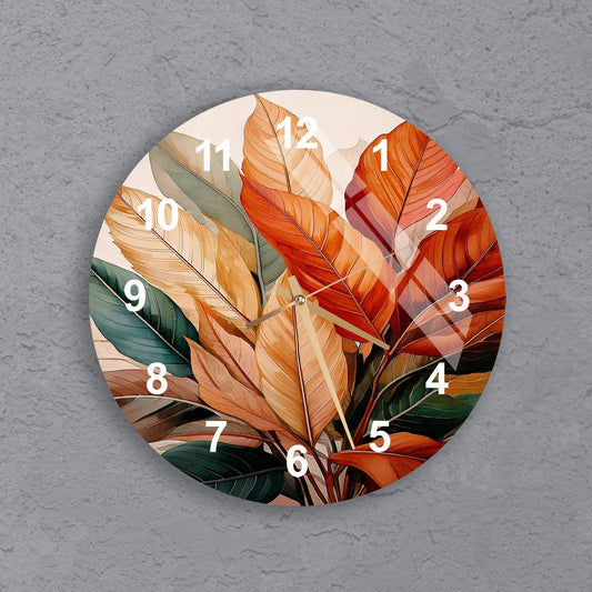 a clock with a painting of leaves on it