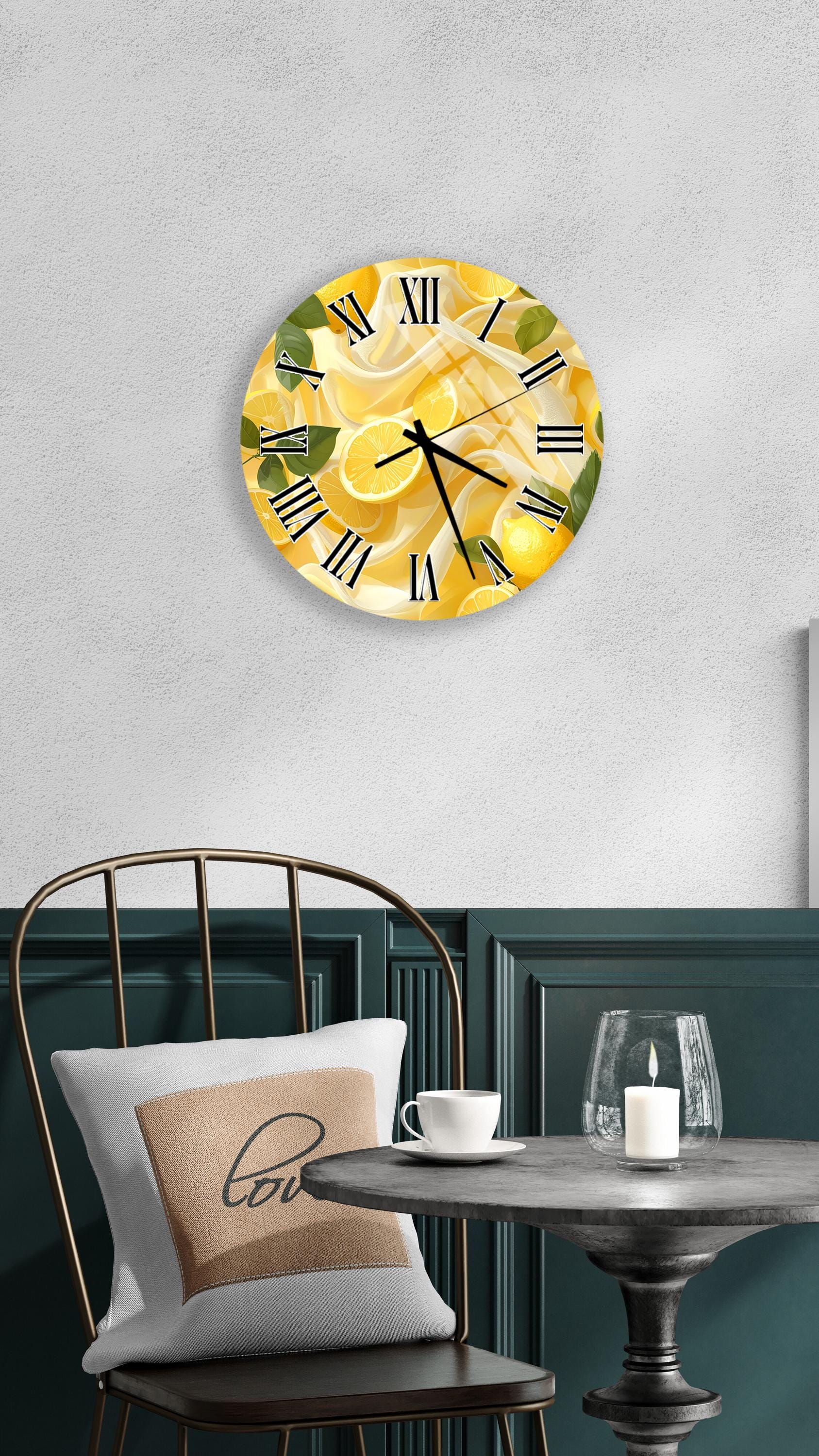 a wall clock with a yellow and green design, hanging on a wall above a table with a white tablecloth.