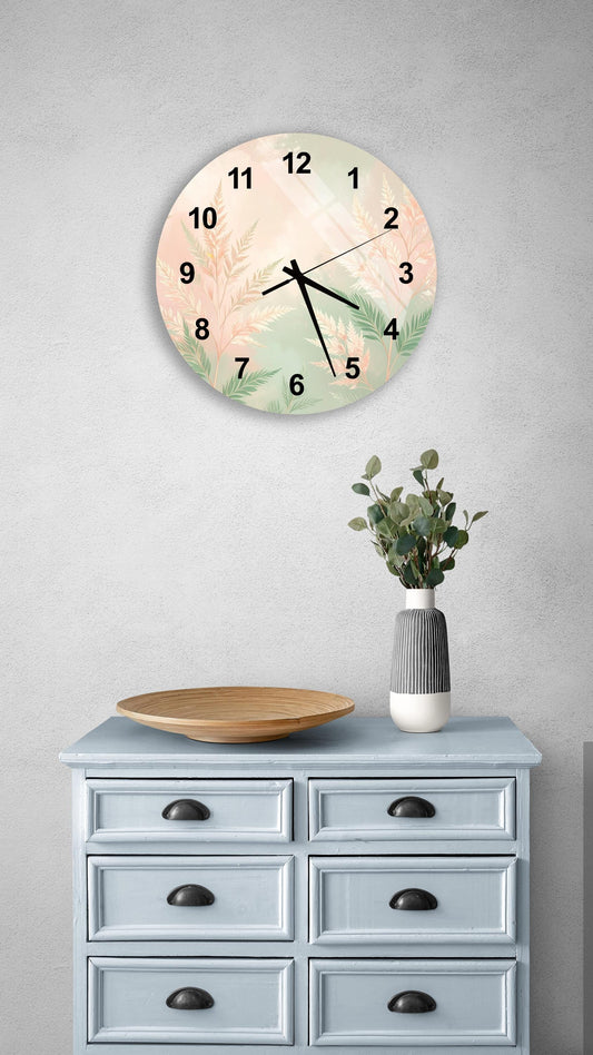 a wall clock with a floral design, a wooden tray, and a vase with greenery on a light blue dresser.